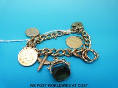 A yellow metal curb link bracelet with four 9ct gold charms,