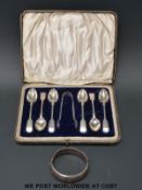 A cased set of hallmarked silver teaspoons and sugar tongs together with a hallmarked silver bangle