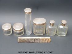 Six glass silver topped dressing table bottles hallmarked for London 1927 and 1928 and a hallmarked