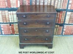 A George III mahogany bachelor's chest of four straight drawers raised on bracket feet with turned