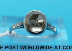 A platinum ring set with a rose cut diamond of approximately 0.