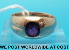 A yellow metal ring set with a ruby (size O)