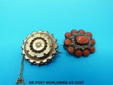 A yellow metal brooch set with carved cabochons and a Victorian mourning brooch