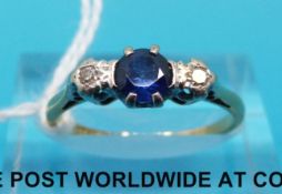 A yellow metal ring marked 18ct with sapphire and two diamonds (size L)