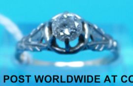 A yellow metal ring marked 18ct set with a round brilliant cut diamond of approximately 0.