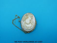 A yellow metal brooch marked 9ct gold set with a cameo.