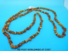 A amber necklace consisting of irregular opaque, translucent and transparent beads, 152cm long,