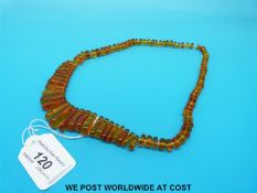 An amber necklace consisting of 87 graduated beads,