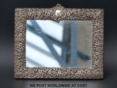 A silver hallmarked mirror with embossed floral and foliate design frame B'ham 1836 (22 x 28cm)