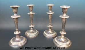 A set of four silver plated candlesticks with gadrooned decoration, 25.