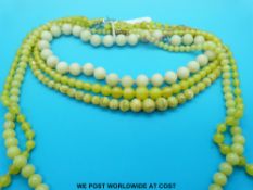 Five beaded yellow glass necklaces