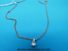 A 9ct white gold necklace with a white metal pendant set with a round brilliant cut diamond