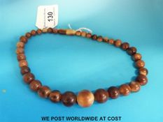 A rhinoceros horn choker necklace consisting of 37 graduated beads, the largest 15.