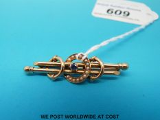 An Edwardian bar brooch marked 15ct gold set with sapphires and pearls