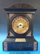 A striking slate clock with bronze coloured dial, Arabic numerals and beetle and poker hands,