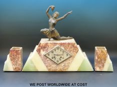 A tri-coloured marble Art Deco clock garniture with dancing lady to top, marked to dial F.