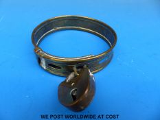 A small Victorian brass dog collar with three slot and loop adjustment and original padlock,