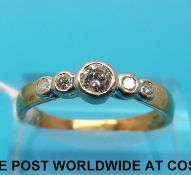 A yellow metal ring set with five round brilliant cut diamonds, the largest approximately 0.