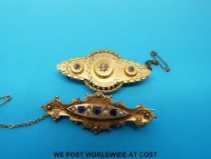 A 15ct gold brooch set with a central diamond and two sapphires and a 9ct gold brooch set with