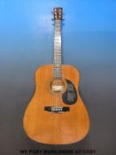 An Encore six string acoustic guitar