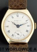 Tiffany & Co 9ct gold wristwatch with Roman numerals, subsidiary seconds dial and blued hands,