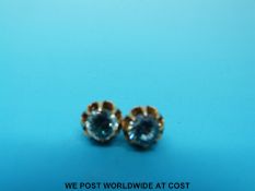 A pair of yellow metal earrings set with zircon