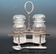 Two cut glass pickle jars and forks on silver plated stand,