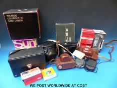 A collection of cameras including two Polaroids,