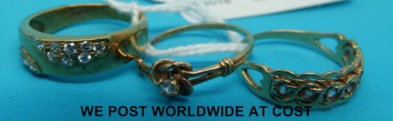 Three 9ct gold rings all set with clear stones in various designs