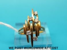 A yellow metal ring marked 750 set with five diamonds (size H)