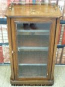 A 19thC inlaid walnut glazed music or pier cabinet with canted corners and brass gallery rail (H85