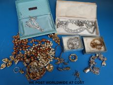 A silver charm bracelet and a small collection of costume jewellery