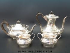 A hallmarked silver four piece tea set with fluted decoration,