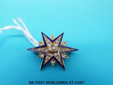 A Victorian brooch in the form of a star set with a central oval cut diamond surrounded by rose cut