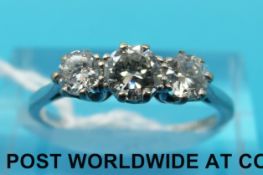 An 18ct white gold ring set with three diamonds in a platinum setting (size N)