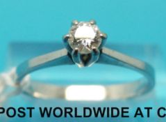 A white metal ring set with a diamond of approximately 0.