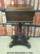 A 19thC rosewood teapoy with fitted interior with fitted four division interior with apertures for
