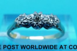 An 18ct gold ring set with diamonds in an illusion setting (size M)