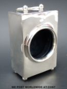 An Edward VII hallmarked silver watch case with swing handle, raised on four ball feet,