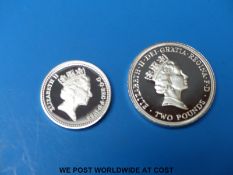 A cased silver Silver Commonwealth Games £2 coin together with a cased silver proof £1 example