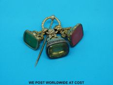 Three yellow metal Victorian seals/ingots with scrolling foliate design and set with quartz and