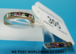 Two 9ct gold rings set with a row of multi coloured gemstones including sapphire, diamond, garnet,