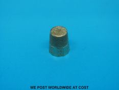 A yellow metal thimble in case, marked 10k (4.