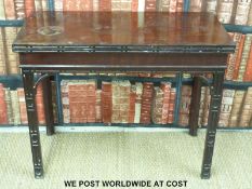 A 19thC mahogany fold over card table with slotted geometric frieze to the edges and legs (H73 x