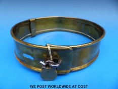 A Victorian brass dog collar with two slot and loop adjustment,