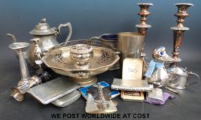 A collection of plated items to include cigarette cases, candlesticks, teapot, vases,