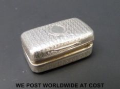 A Georgian hallmarked silver vinagrette of cushion shape, with engraved decoration,