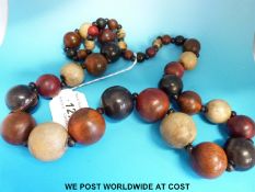 A rhinoceros horn necklace consisting of 37 graduated spherical beads stained in three colours,