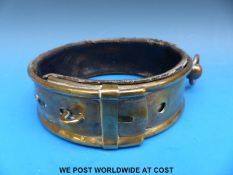 A Victorian brass dog collar with two slot and loop adjustment, ring tether,