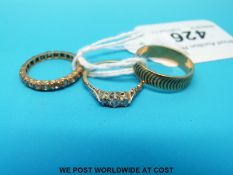 A yellow metal ring set with diamonds and two 9ct gold rings (6.
